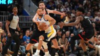 Golden State Warriors guard Stephen Curry (30) holds onto the ball next to Houston Rockets center Alperen Sengun (28) and guard Amen Thompson (1) in the fourth quarter at the Chase Center.