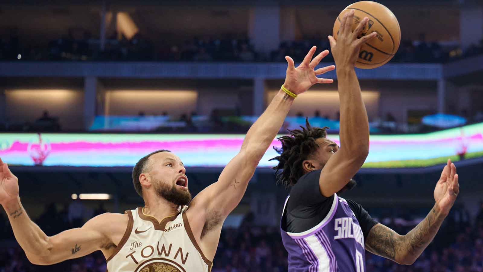 Sacramento Kings guard Malik Monk (0) drives to the basket against Golden State Warriors guard Stephen Curry (30) during the first quarter at Golden 1 Center.