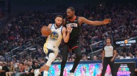 Golden State Warriors guard Stephen Curry (30) dribbles the ball next to Houston Rockets forward Kevin Durant (7) in the first quarter at the Chase Center.