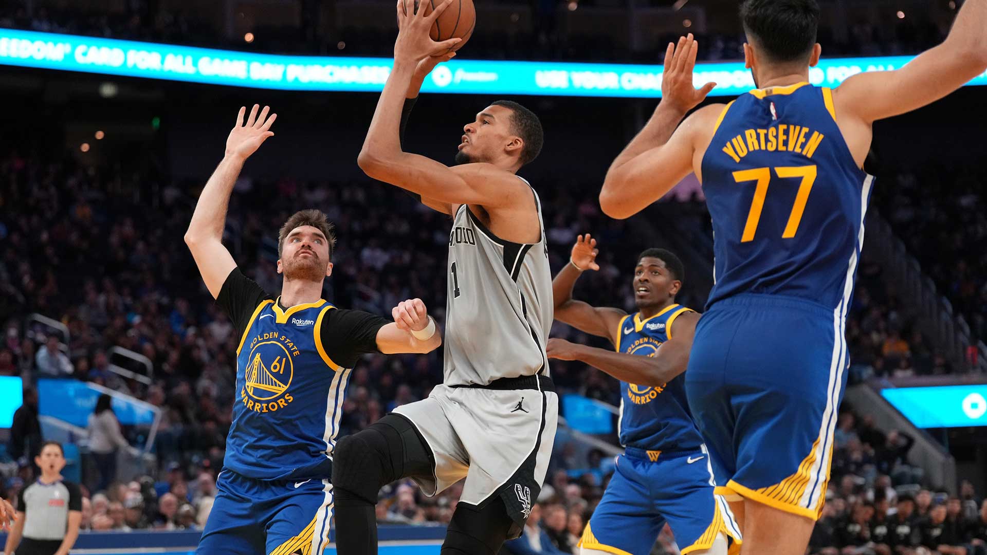 San Antonio Spurs center Victor Wembanyama (1) drives to the hoop between Golden State Warriors guard Pat Spencer (61) and center Omer Yurtseven (77) in the fourth quarter at the Chase Center.
