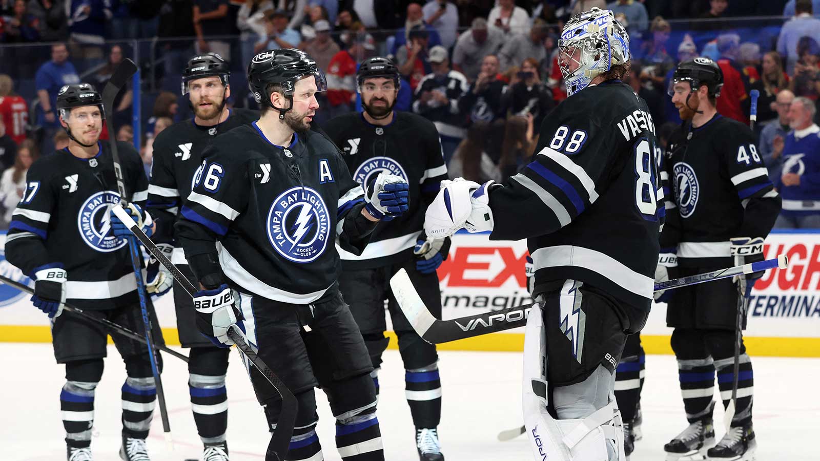 Tampa Bay Lightning goaltender Andrei Vasilevskiy (88) and Tampa Bay Lightning right wing Nikita Kucherov (86) celebrate after they beat the Florida Panthers at Amalie Arena.