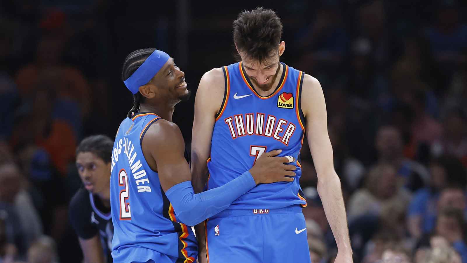 Thunder guard Shai Gilgeous-Alexander (2) and center Chet Holmgren (7) laugh after a play against the Utah Jazz during the second half at Paycom Center