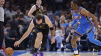 Lakers guard Luka Doncic (77) looses the ball during a drive against Oklahoma City Thunder guard Jalen Williams (8) during the second half at Paycom Center