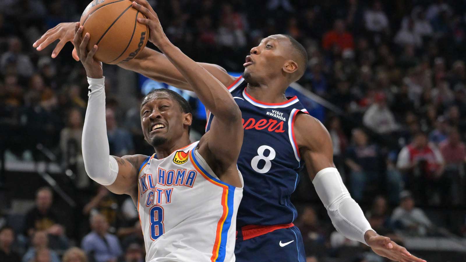 Clippers guard Kris Dunn (8) defends Oklahoma City Thunder guard Jalen Williams (8) as he drives to the basket in the second half at Intuit Dome