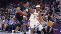 Oklahoma City Thunder guard Shai Gilgeous-Alexander (2) drives past Detroit Pistons forward Ronald Holland II (5) during a game at Paycom Center.