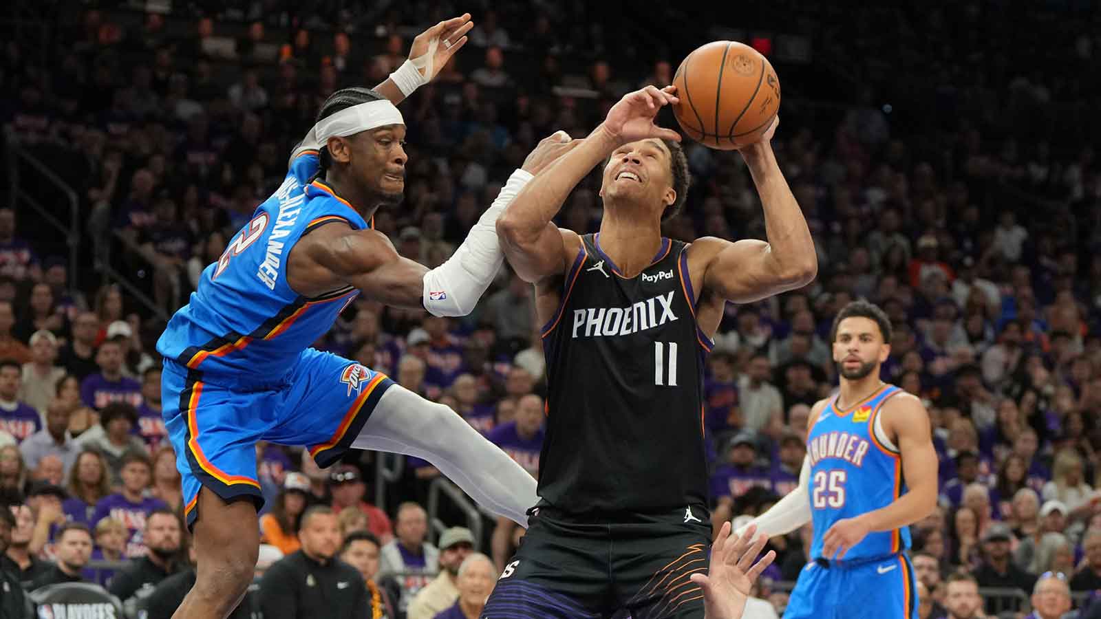 Suns forward Oso Ighodaro (11) drives on Oklahoma City Thunder guard Shai Gilgeous-Alexander (2) in the second half during game three of the first round of the 2026 NBA Playoffs at Mortgage Matchup Center