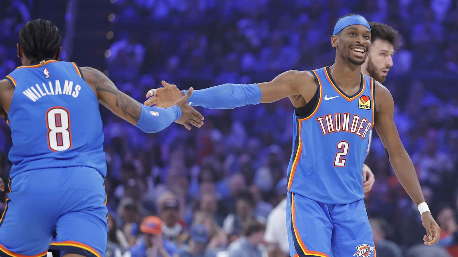 Thunder guard Shai Gilgeous-Alexander (2) celebrates with Oklahoma City Thunder guard Jalen Williams (8) after scoring against the Utah Jazz during the first quarter at Paycom Center