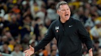 Arizona head coach Tommy Lloyd shouts toward the court in the first half of their Final Four game against Michigan at Lucas Oil Stadium in Indianapolis on Saturday, April 4, 2026.