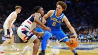 UCLA Bruins guard Trent Perry (0) dribbles the ball against the UConn Huskies in the first half during a second round game of the men's 2026 NCAA Tournament at Xfinity Mobile Arena.