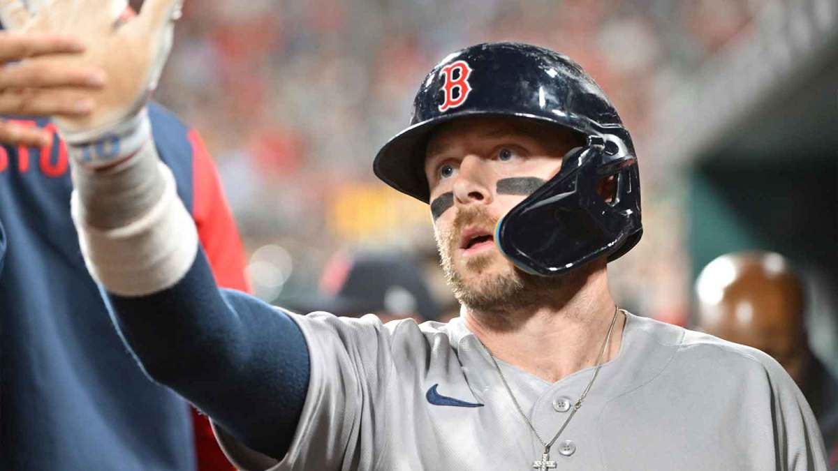 Boston Red Sox shortstop Trevor Story (10) is congratulated in the dugout after scoring in the fourth inning against the St. Louis Cardinals at Busch Stadium.