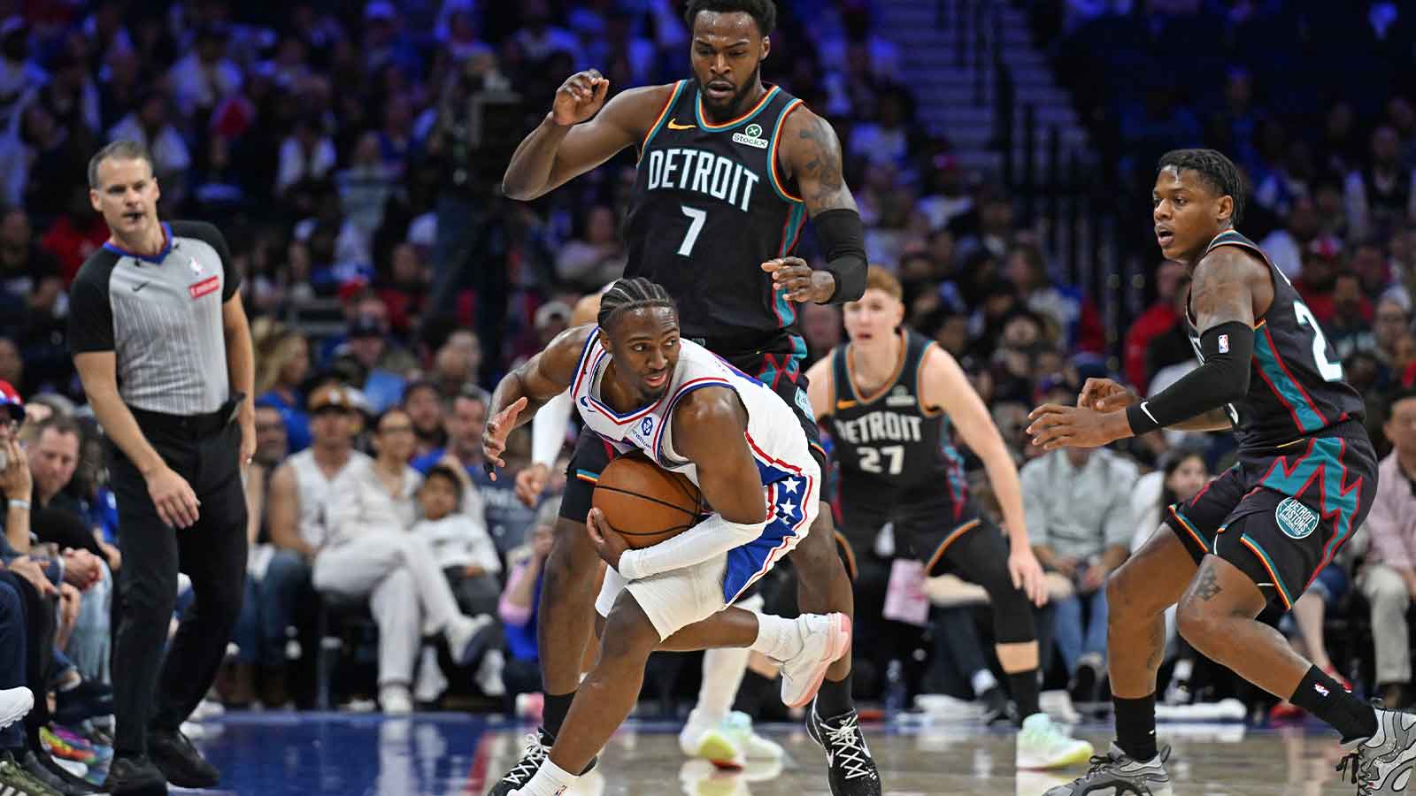 Philadelphia 76ers guard Tyrese Maxey (0) is fouled by Detroit Pistons forward Paul Reed (7) during the first half at Xfinity Mobile Arena.