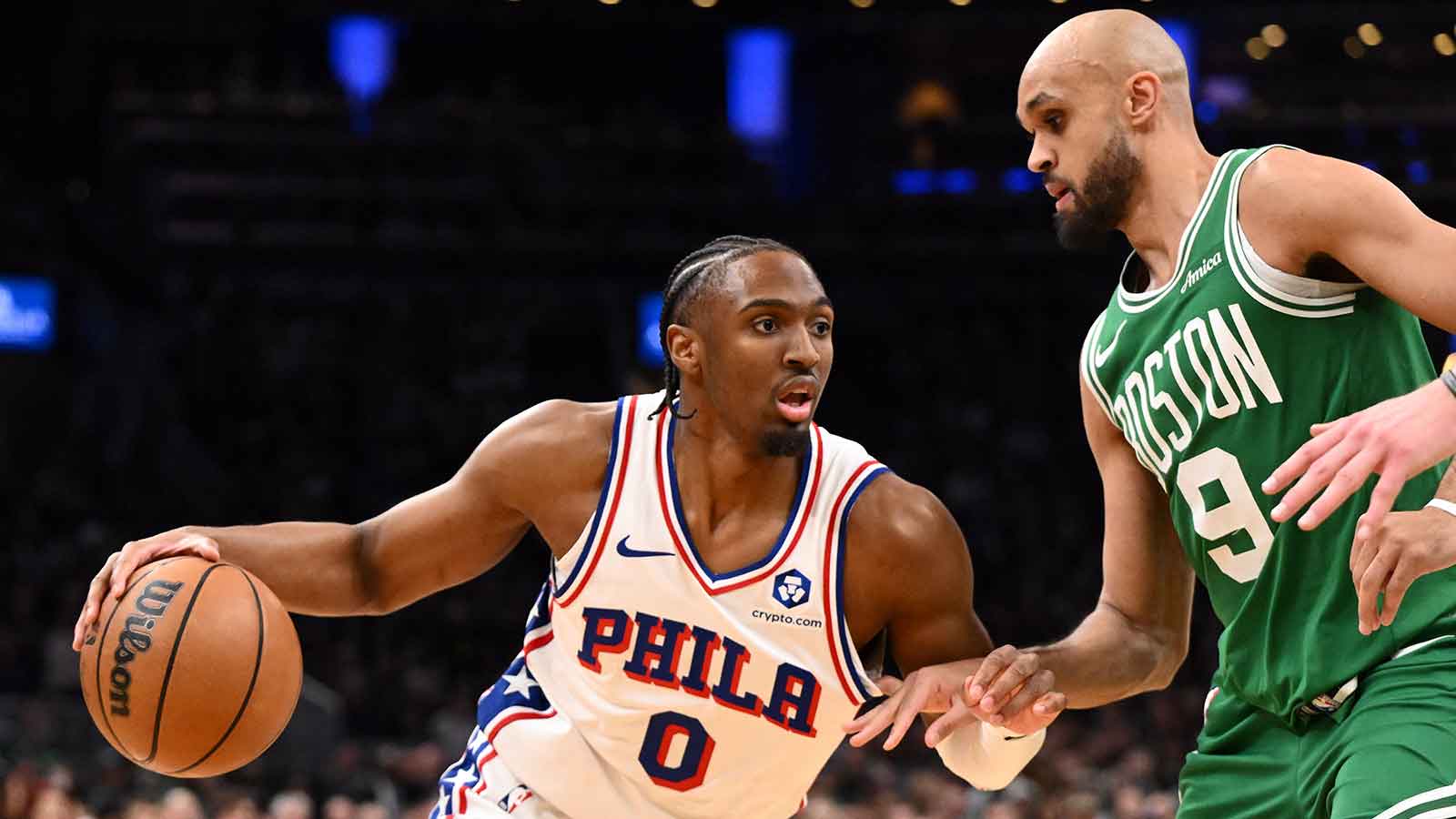 Philadelphia 76ers guard Tyrese Maxey (0) drives to the basket against Boston Celtics guard Derrick White (9) in the first half of a game two of the first round of the 2026 NBA Playoffs at TD Garden.