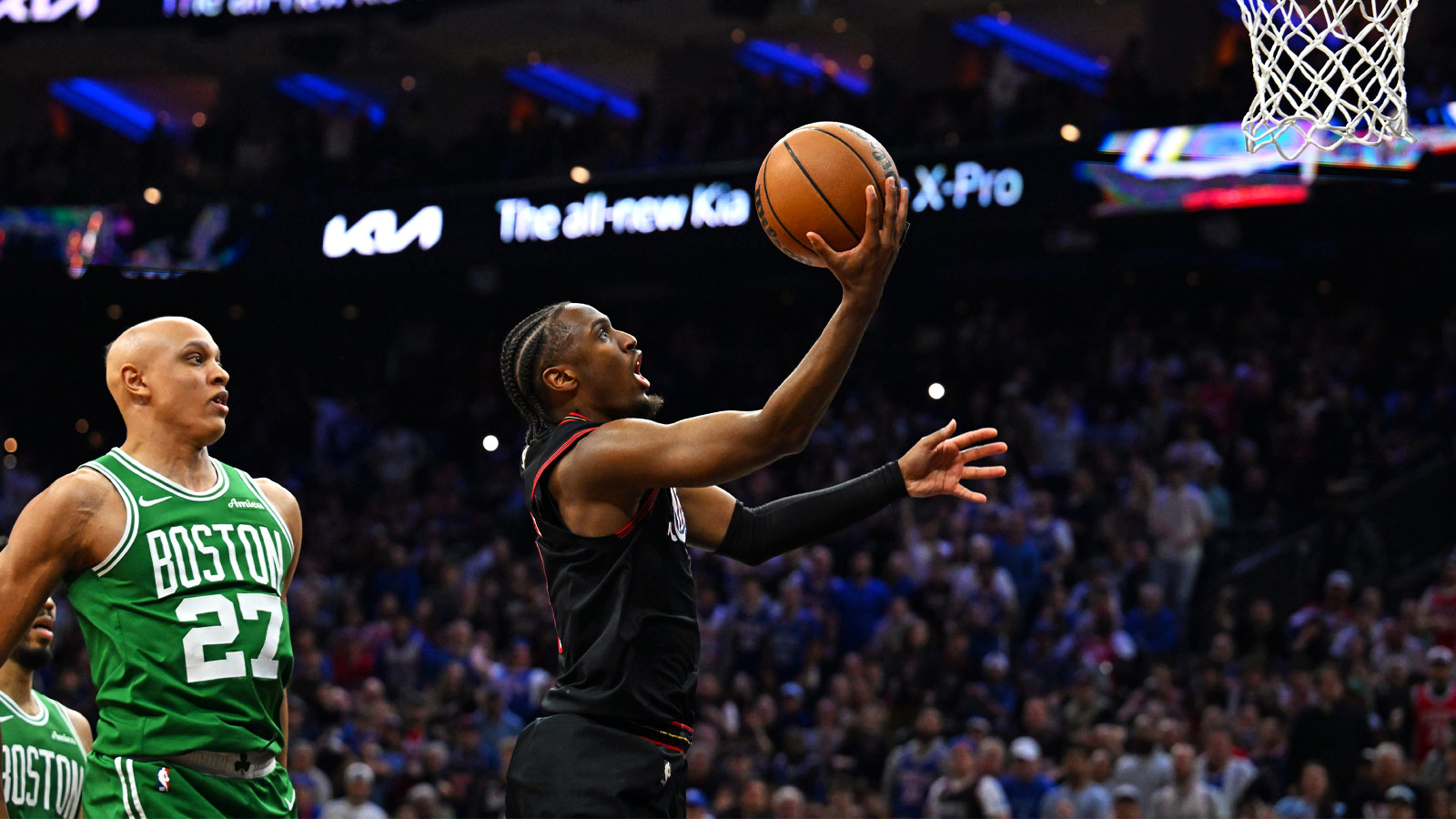 Philadelphia 76ers guard Tyrese Maxey (0) drives against Boston Celtics guard Jordan Walsh (27) during the second half at Xfinity Mobile Arena.
