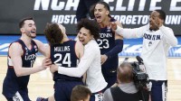 UConn Huskies forward Alex Karaban (11) celebrates with UConn Huskies guard Braylon Mullins (24) after defeating the Duke Blue Devils in an Elite Eight game of the East Regional of the men's 2026 NCAA Tournament at Capital One Arena.
