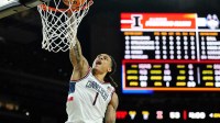 UConn Huskies guard Solo Ball (1) dunks against the Illinois Fighting Illini during the second half of a semifinal of the Final Four of the men's 2026 NCAA Tournament at Lucas Oil Stadium.
