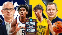 IMAGE: On one side: UConn HC Dan Hurley, F Tarris Reed Jr. UConn logo Other side: Michigan HC Dusty May, C Aday Mara, Michigan logo 2026 Final Four logo in front