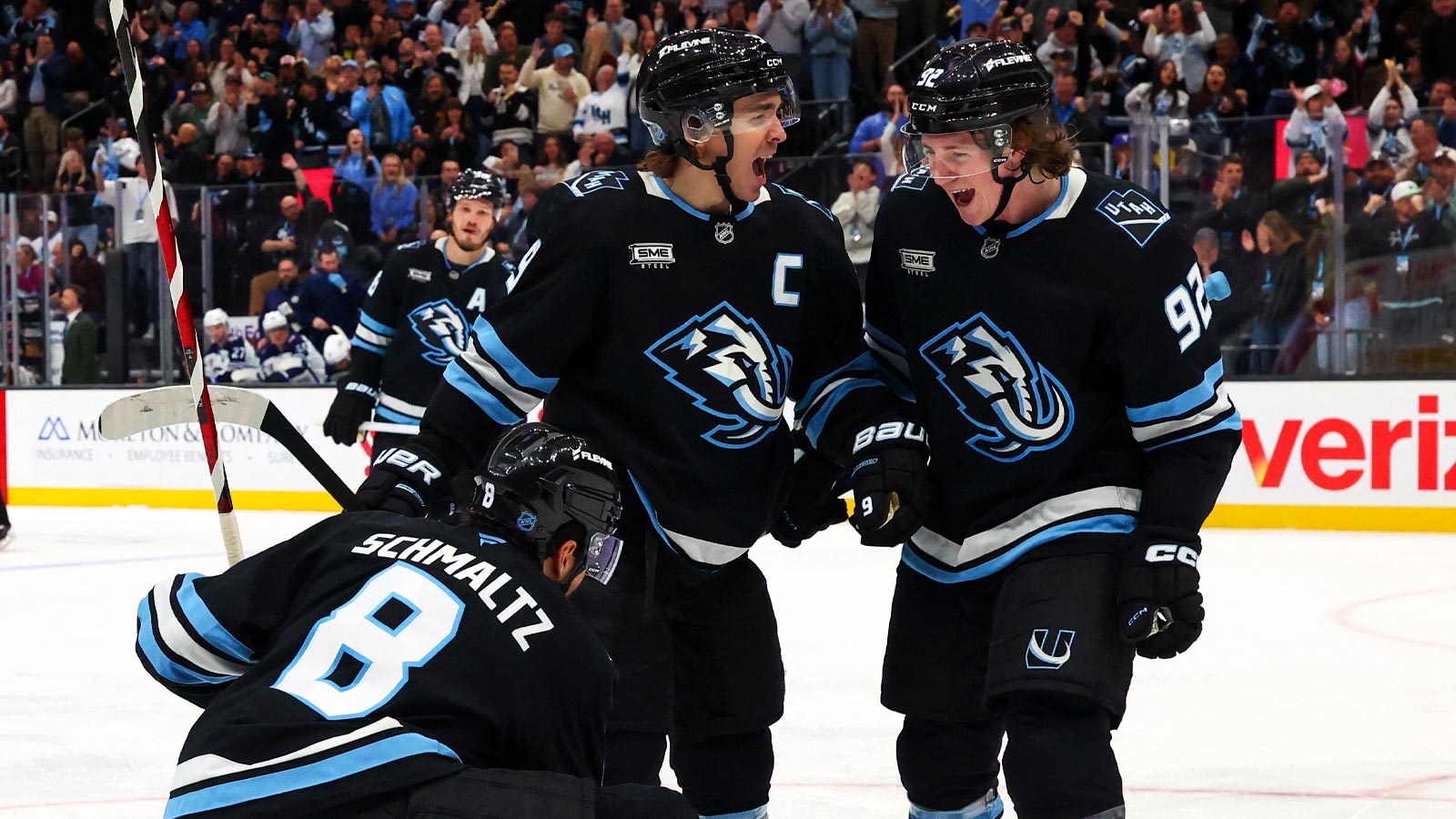 Utah Mammoth center Nick Schmaltz (8) celebrates with right wing Clayton Keller (9) and center Logan Cooley (92) after scoring a goal against the Winnipeg Jets during the third period at Delta Center.