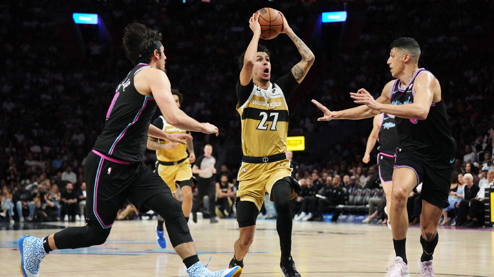 Washington Wizards guard Will Riley (27) drives to the basket as Miami Heat forward Simone Fontecchio (0) and forward Jaime Jaquez Jr. (11) defend during the second half at Kaseya Center.