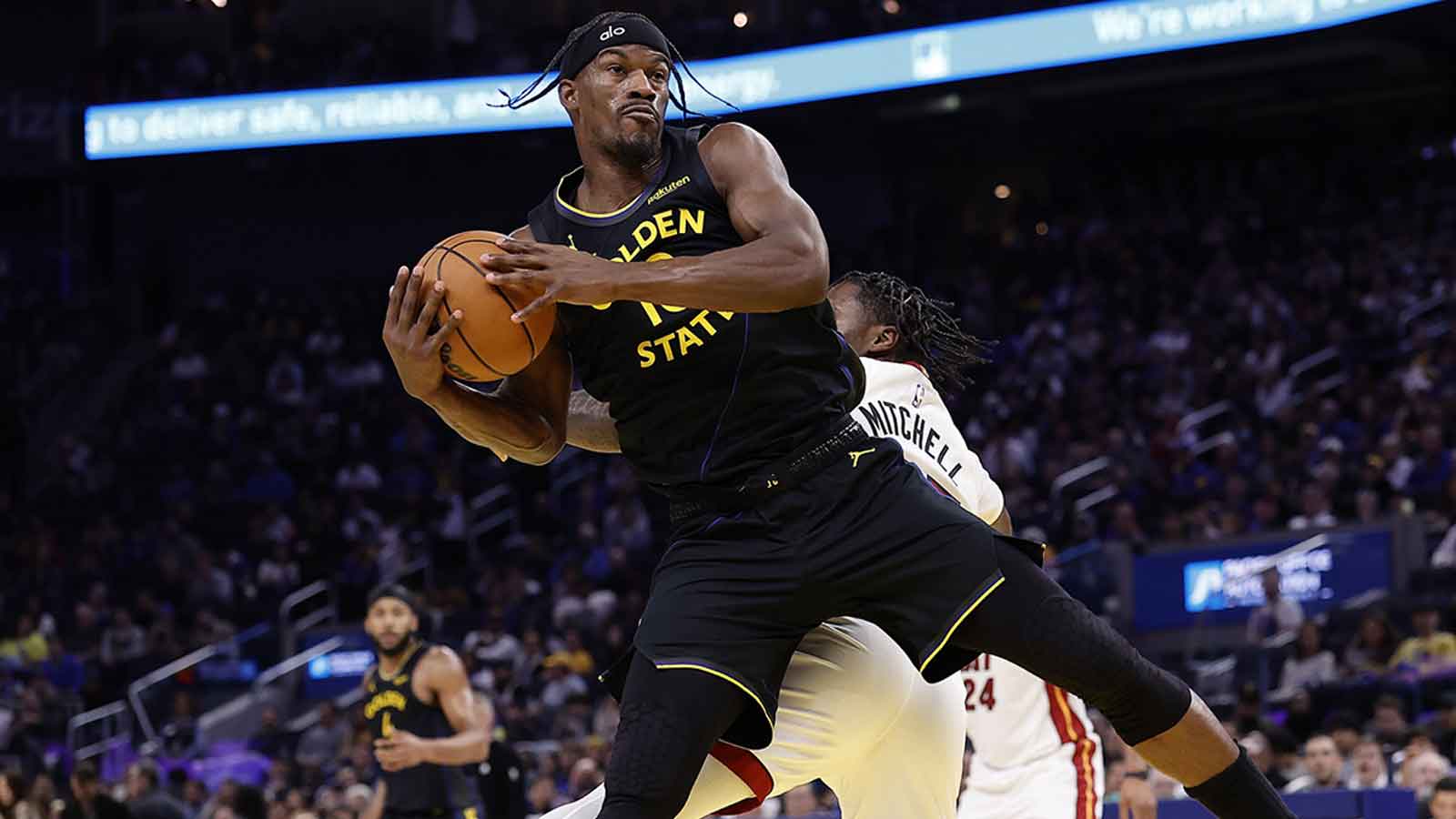 Warriors forward Jimmy Butler III (10) on a play against Miami Heat guard Davion Mitchell (45) resulting in a knee injury during the third quarter at Chase Center