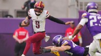 Washington Commanders quarterback Jayden Daniels (5) rushes the ball past Minnesota Vikings outside linebacker Andrew van Ginkel (43) during the first half at U.S. Bank Stadium.