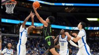 South Florida's Wes Enis (2) goes for a layup as Memphis' Julius Thedford (15) guards him during the game between Memphis and the University of South Florida at FedExForum in Memphis, Tenn., on March 5, 2026.