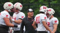 Wisconsin football offensive line coach AJ Blazek works with players during practice, July 30, 2025, at Ralph E. Davis Pioneer Stadium in Platteville, Wisconsin.