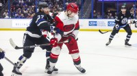 Tampa Bay Lightning forward Yanni Gourde (37) checks Carolina Hurricanes defenseman Sean Walker (26) in the second period at Benchmark International Arena.