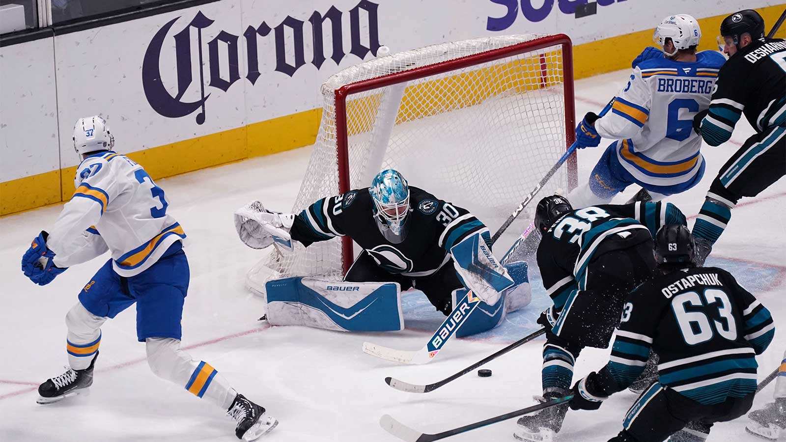 San Jose, California, USA; San Jose Sharks goaltender Yaroslav Askarov (30) defends the goal with the help of defenseman Mario Ferraro (38), defenseman Vincent Desharnais (5), and center Zack Ostapchuk (63) as St. Louis Blues center Jack Finley (37) and defenseman Philip Broberg (6) crash the net in the third period at SAP Center at San Jose.