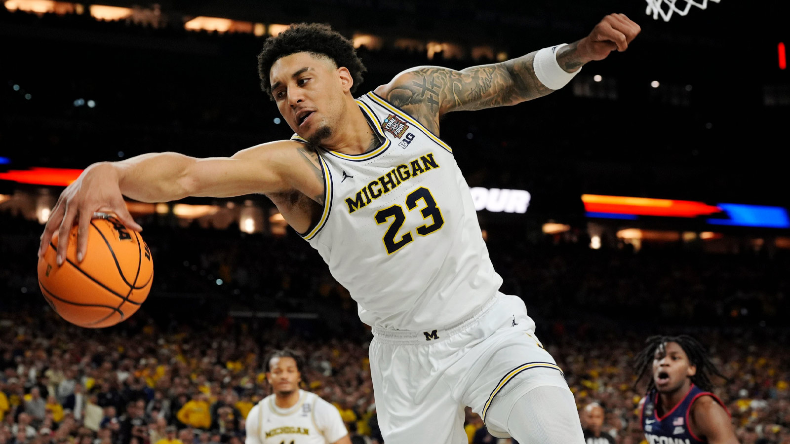 Michigan forward Yaxel Lendeborg (23) looks to keep the ball in bounds during the second half of the NCAA national championship game against Connecticut at Lucas Oil Stadium in Indianapolis on Monday, April 6, 2026.