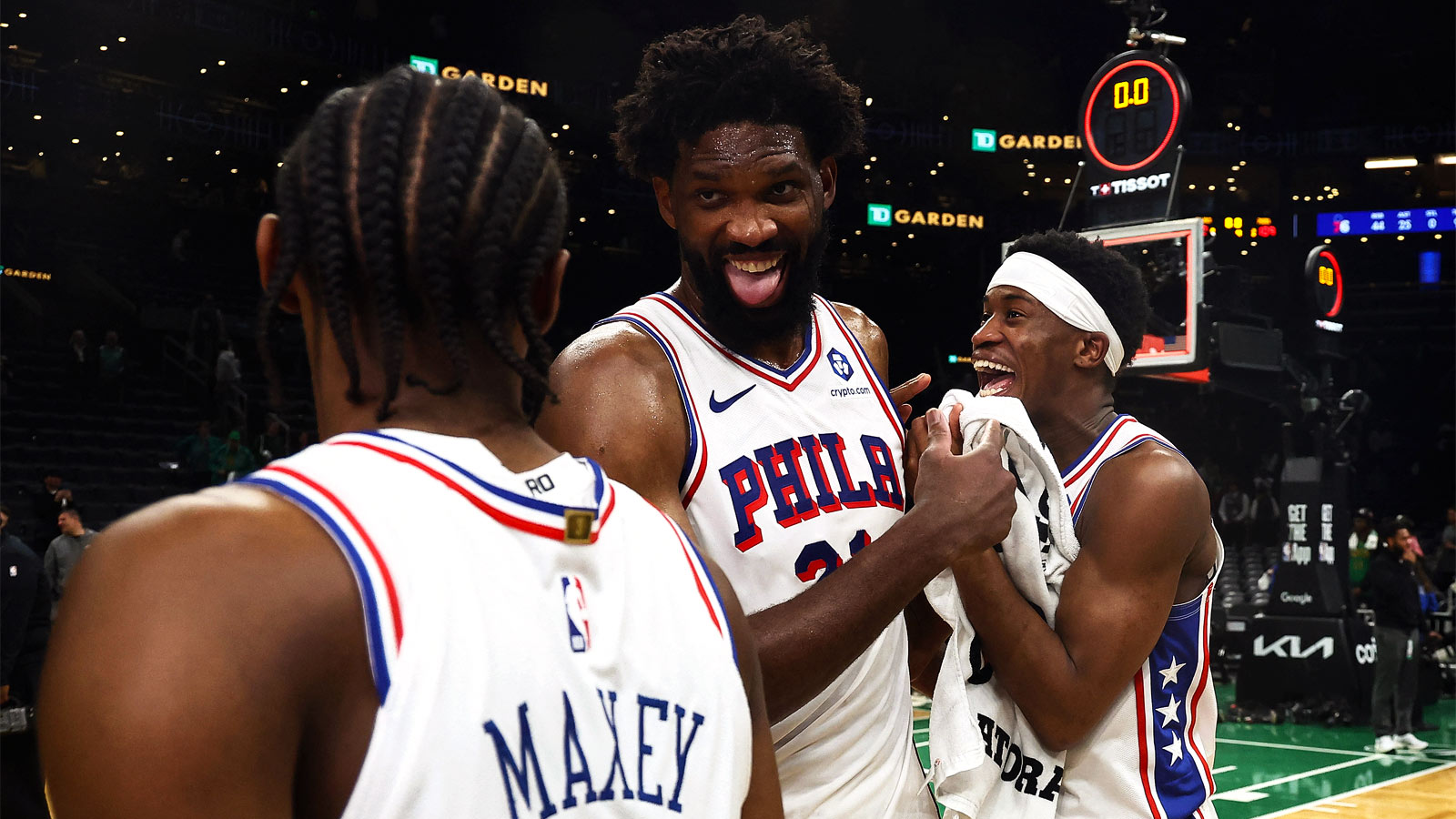 Philadelphia 76ers center Joel Embiid (21) celebrates with guard Tyrese Maxey (0) and guard Vj Edgecombe (77)] following their win over the Boston Celtics in game seven of the first round of the 2026 NBA Playoffs at TD Garden.