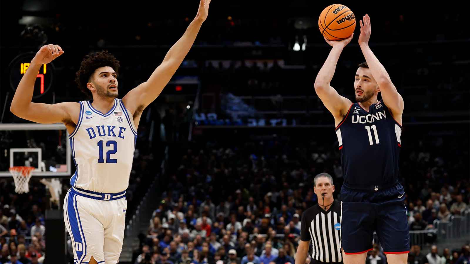UConn Huskies forward Alex Karaban (11) shoots the ball over Duke Blue Devils forward Cameron Boozer (12) during an Elite Eight game of the East Regional of the men's 2026 NCAA Tournament at Capital One Arena. 