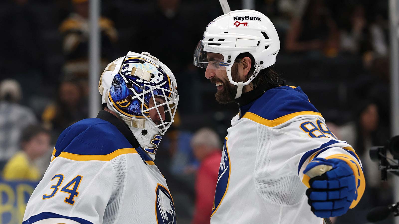Buffalo Sabres right wing Alex Tuch (89) celebrates with goaltender Alex Lyon (34) after their 4-1 win over the Boston Bruins in game six of the first round of the 2026 Stanley Cup Playoffs at TD Garden.