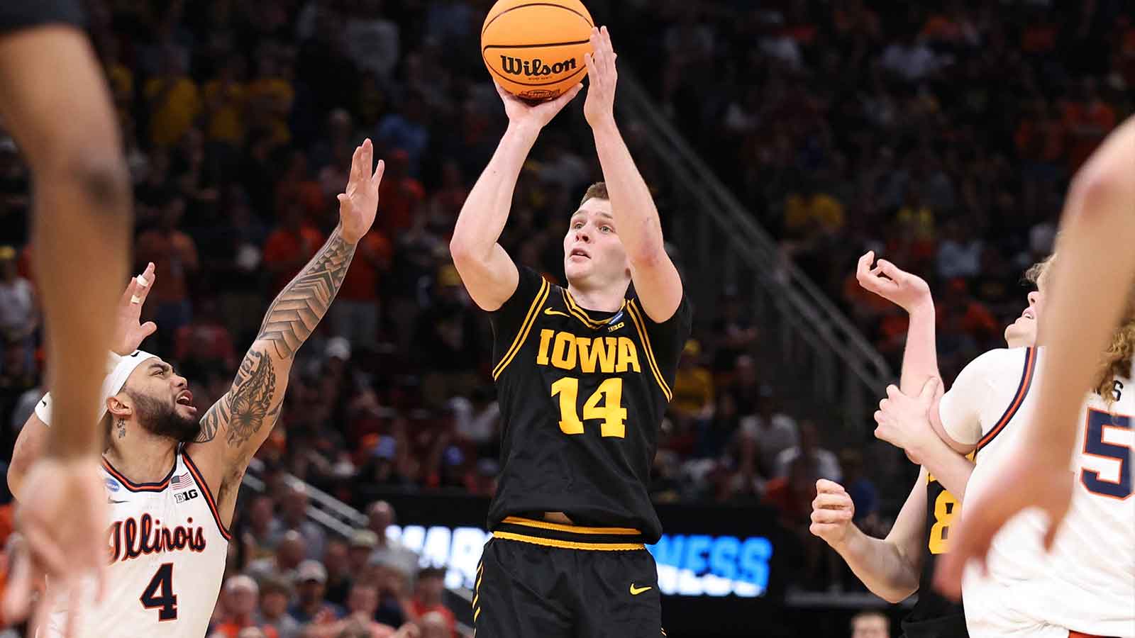 Iowa Hawkeyes guard Bennett Stirtz (14) shoots against Illinois Fighting Illini guard Kylan Boswell (4) in the second half during an Elite Eight game of the South Regional of the men's 2026 NCAA Tournament at Toyota Center. 