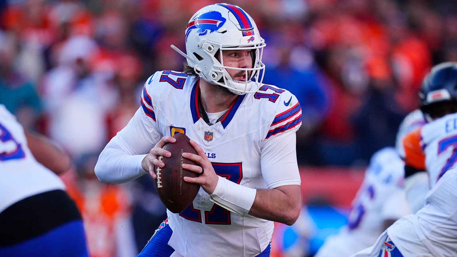Buffalo Bills quarterback Josh Allen (17) rolls out during the second quarter of an AFC Divisional Round playoff game against the Denver Broncos at Empower Field at Mile High.