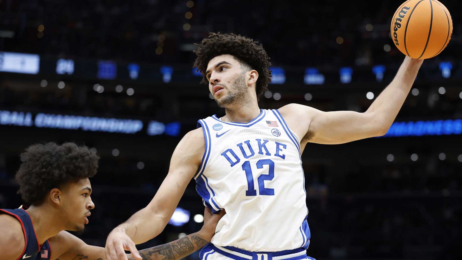 Duke Blue Devils forward Cameron Boozer (12) grabs the ball in front of UConn Huskies forward Jaylin Stewart (3) in the first half during an Elite Eight game of the East Regional of the men's 2026 NCAA Tournament at Capital One Arena.