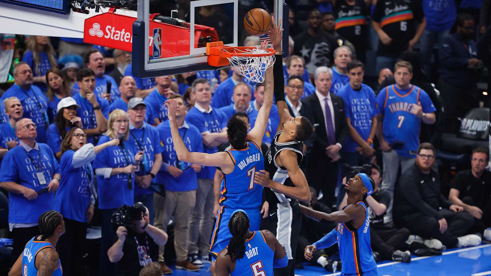 San Antonio Spurs center Victor Wembanyama (1) shoots while defended by Oklahoma City Thunder center Chet Holmgren (7) in the first quarter during game one of the western conference finals for the 2026 NBA playoffs at Paycom Center. 