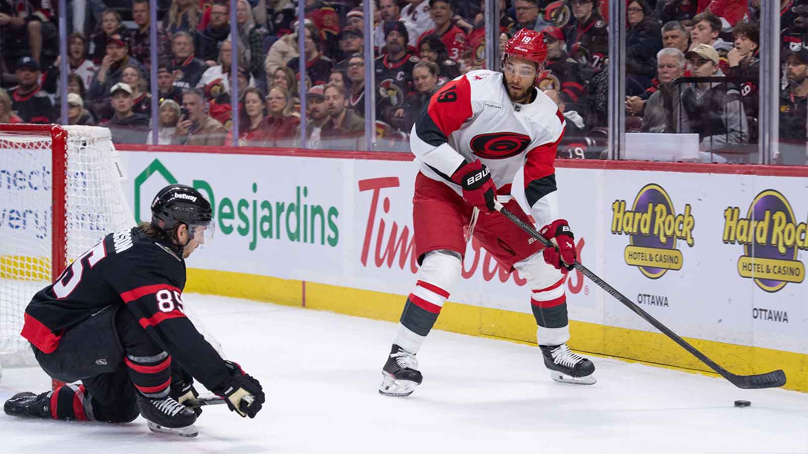  Carolina Hurricanes defenseman K'Andre Miller (19) skates with the puck as Ottawa Senators defenseman Jake Sandreson (85) gets in position to block in the second period at the Canadian Tire Centre. 