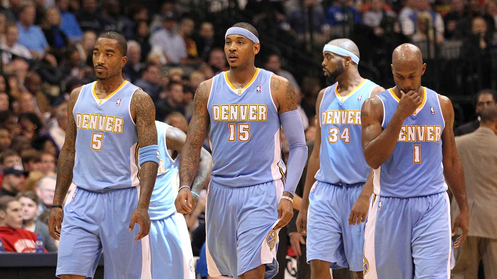 Denver Nuggets forward Carmelo Anthony (15) leads the team onto the court after a timeout from the game against the Dallas Mavericks at American Airlines Center.