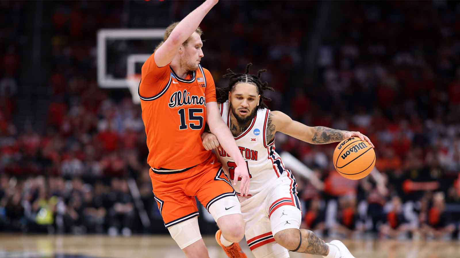 Houston Cougars guard Emanuel Sharp (21) dribbles the ball against Illinois Fighting Illini forward Jake Davis (15) in the first half during a Sweet Sixteen game of the South Regional of the men's 2026 NCAA Tournament at Toyota Center.