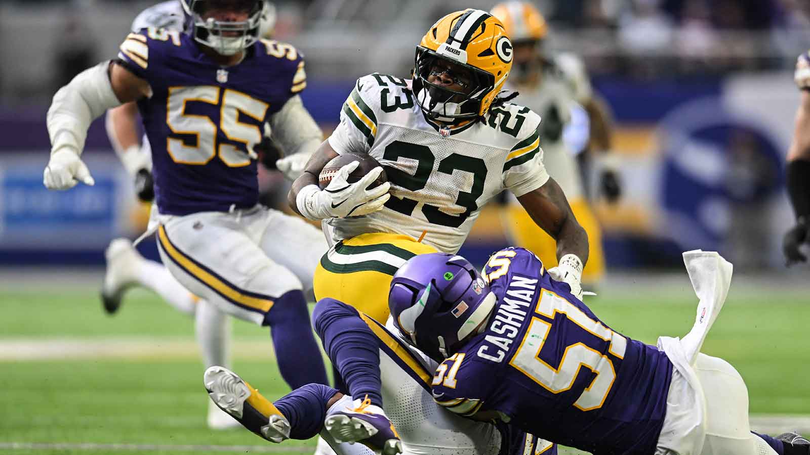 Green Bay Packers running back Emanuel Wilson (23) runs the ball against Minnesota Vikings linebacker Blake Cashman (51) during the fourth quarter at U.S. Bank Stadium. 
