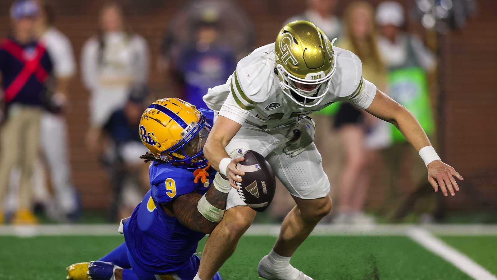 Georgia Tech Yellow Jackets quarterback Haynes King is sacked by Pittsburgh Panthers linebacker Kyle Louis
