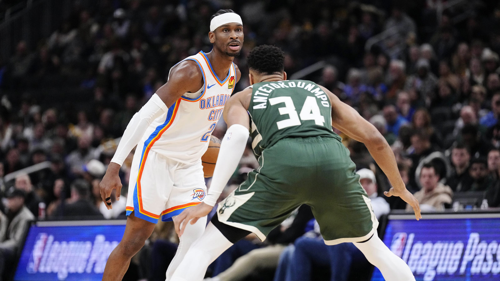 Jan 21, 2026; Oklahoma City Thunder guard Shai Gilgeous-Alexander (2) drives against Milwaukee Bucks forward Giannis Antetokounmpo (34) in the first half at Fiserv Forum.