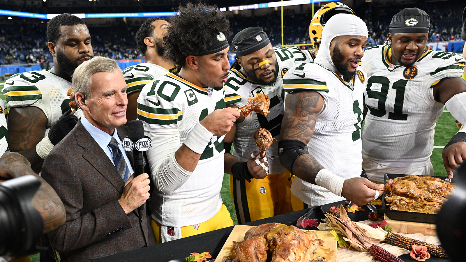 Green Bay Packers Jordan Love (10), Micah Parsons (1) and Warren Brinson (91) eat turkey on Thanksgiving Day.