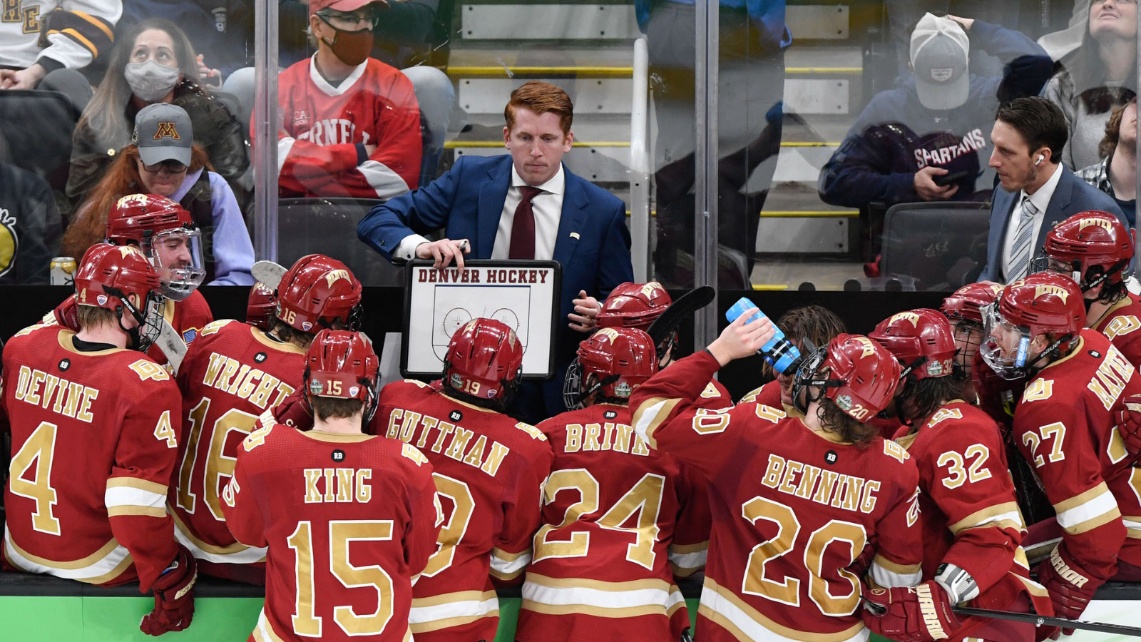 Denver Pioneers head coach David Carle talks with his team during a timeout during the third period of the 2022 Frozen Four college ice hockey national championship game against the Minnesota State Mavericks at TD Garden.