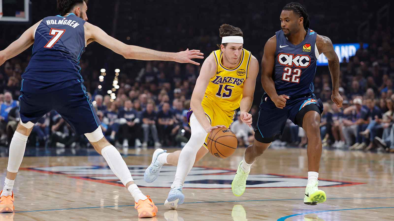Los Angeles Lakers guard Austin Reaves (15) drives between Oklahoma City Thunder center Chet Holmgren (7) and guard Cason Wallace (22) in the first half during game two of the second round of the 2026 NBA Playoffs at Paycom Center.