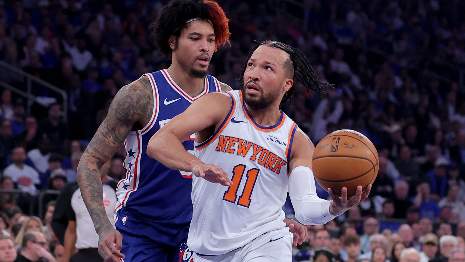 New York Knicks guard Jalen Brunson (11) drives to the basket against Philadelphia 76ers forward Kelly Oubre Jr. (9) during the first quarter of game one of the eastern conference semifinal round of the 2026 NBA Playoffs at Madison Square Garden. 