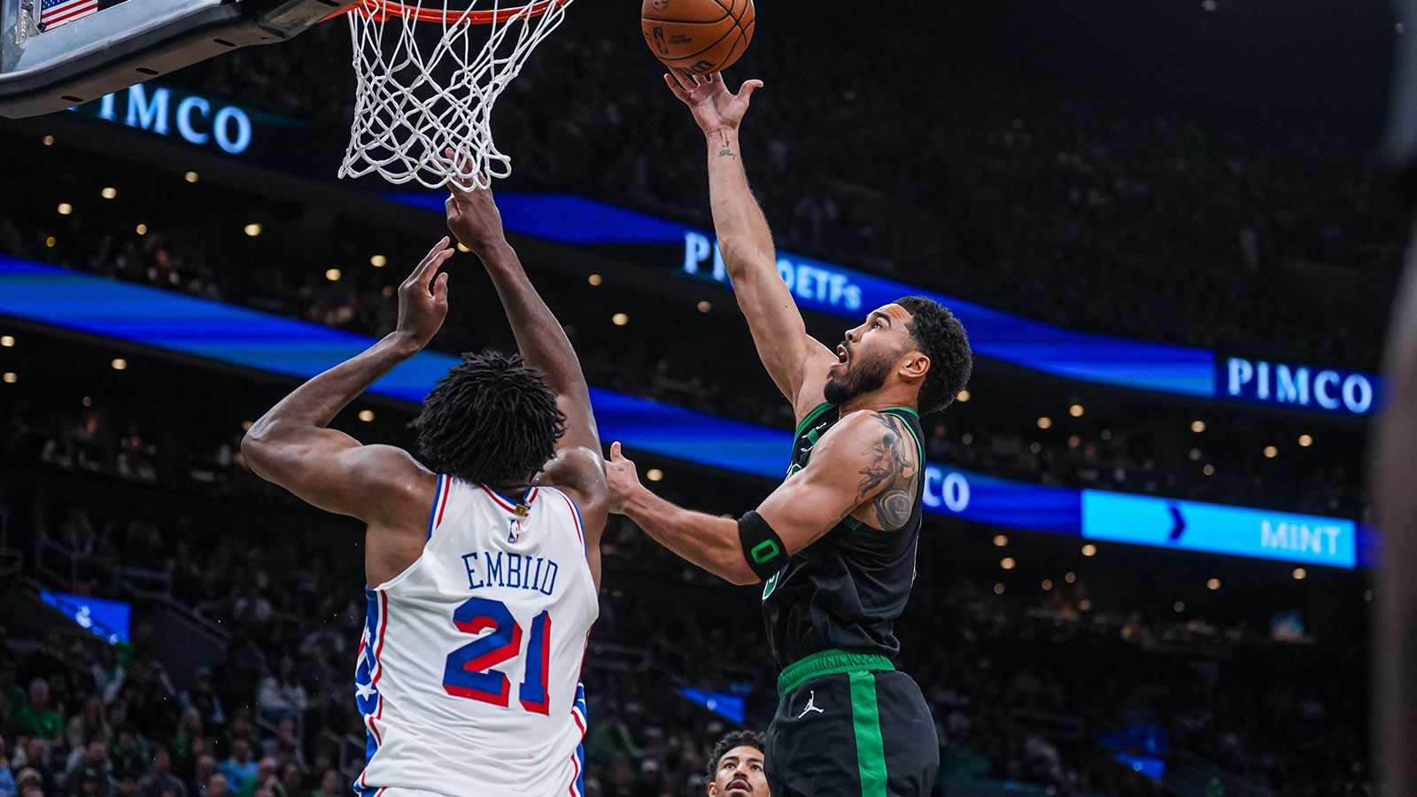 Boston Celtics forward Jayson Tatum (0) shoots the ball against Philadelphia 76ers center Joel Embiid (21) in the second half during game five of the first round of the 2026 NBA Playoffs at TD Garden.