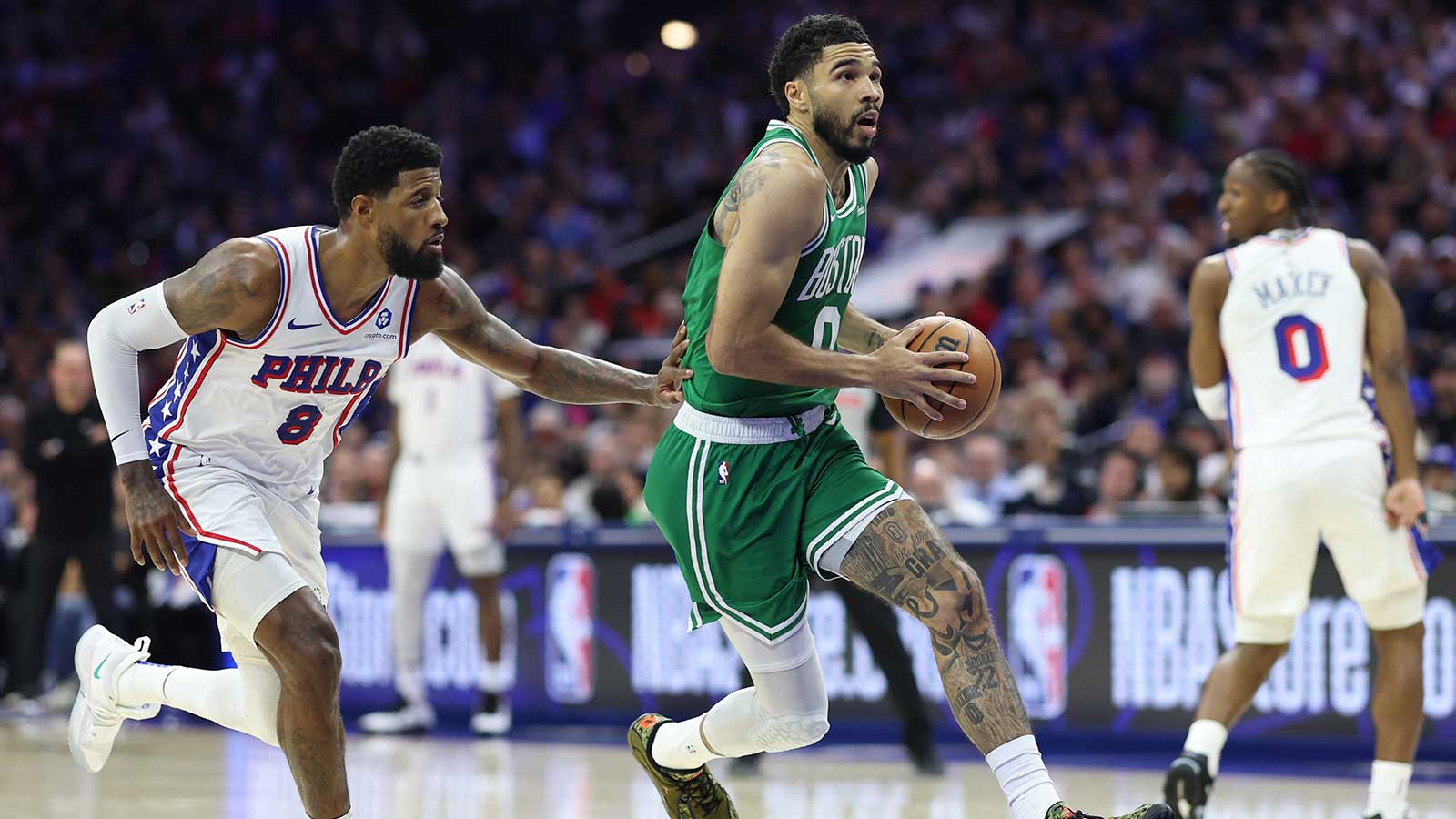 Boston Celtics forward Jayson Tatum (0) drives past Philadelphia 76ers forward Paul George (8) during the first quarter at Xfinity Mobile Arena. 
