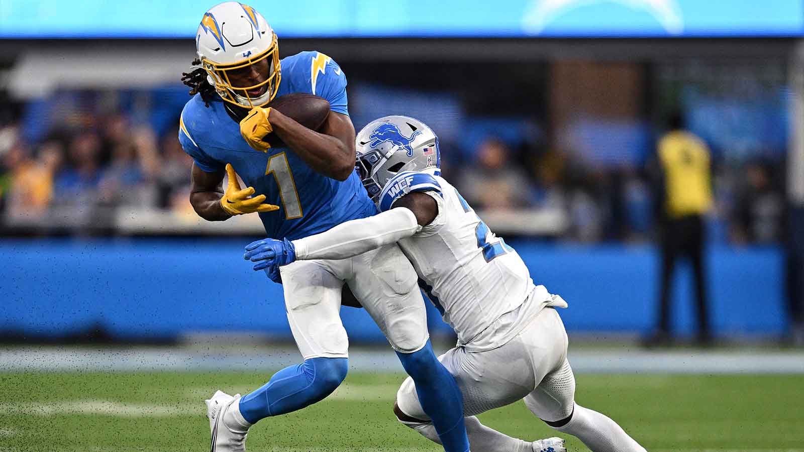 Los Angeles Chargers wide receiver Quentin Johnston (1) is tackled by Detroit Lions cornerback Jerry Jacobs (23) during the second half at SoFi Stadium.