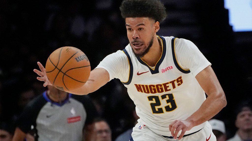 Denver Nuggets forward Cameron Johnson (23) goes after the ball against the Minnesota Timberwolves in the third quarter at Target Center.